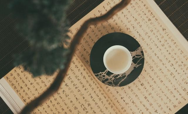 A picture shows a cup of tea on a book.